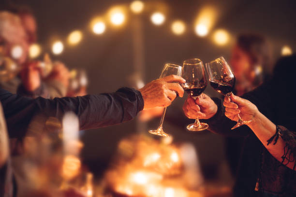 Guests toasting glasses of wine at an elegant evening gathering