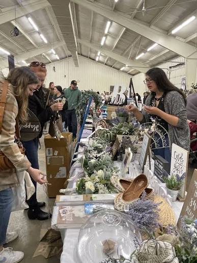 Shoppers browsing wedding décor and pre-loved details at a swap market